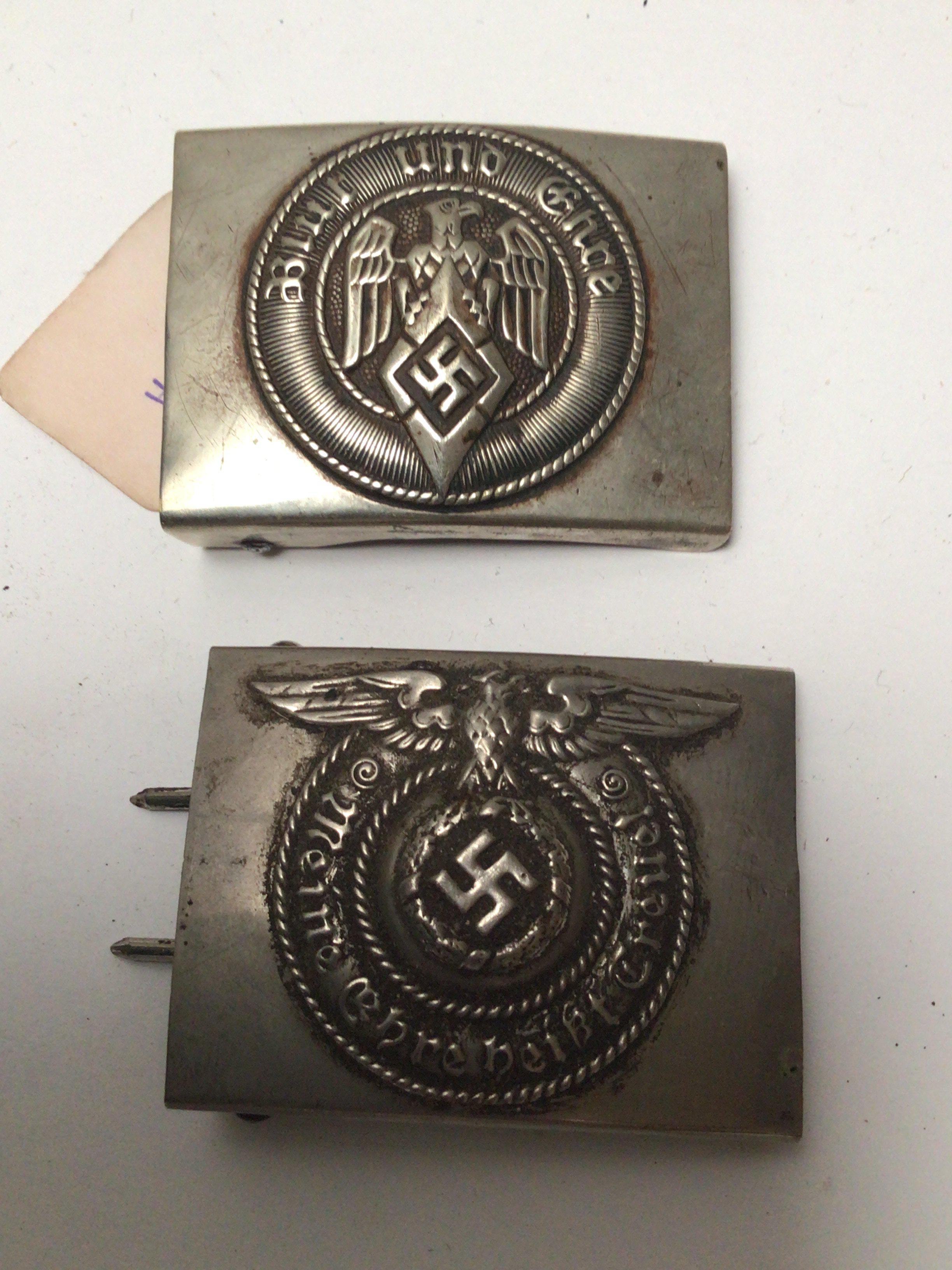 A German Third Reich Hitler Youth belt buckle and a Waffen SS NCO belt buckle both with makers stamps. (2)