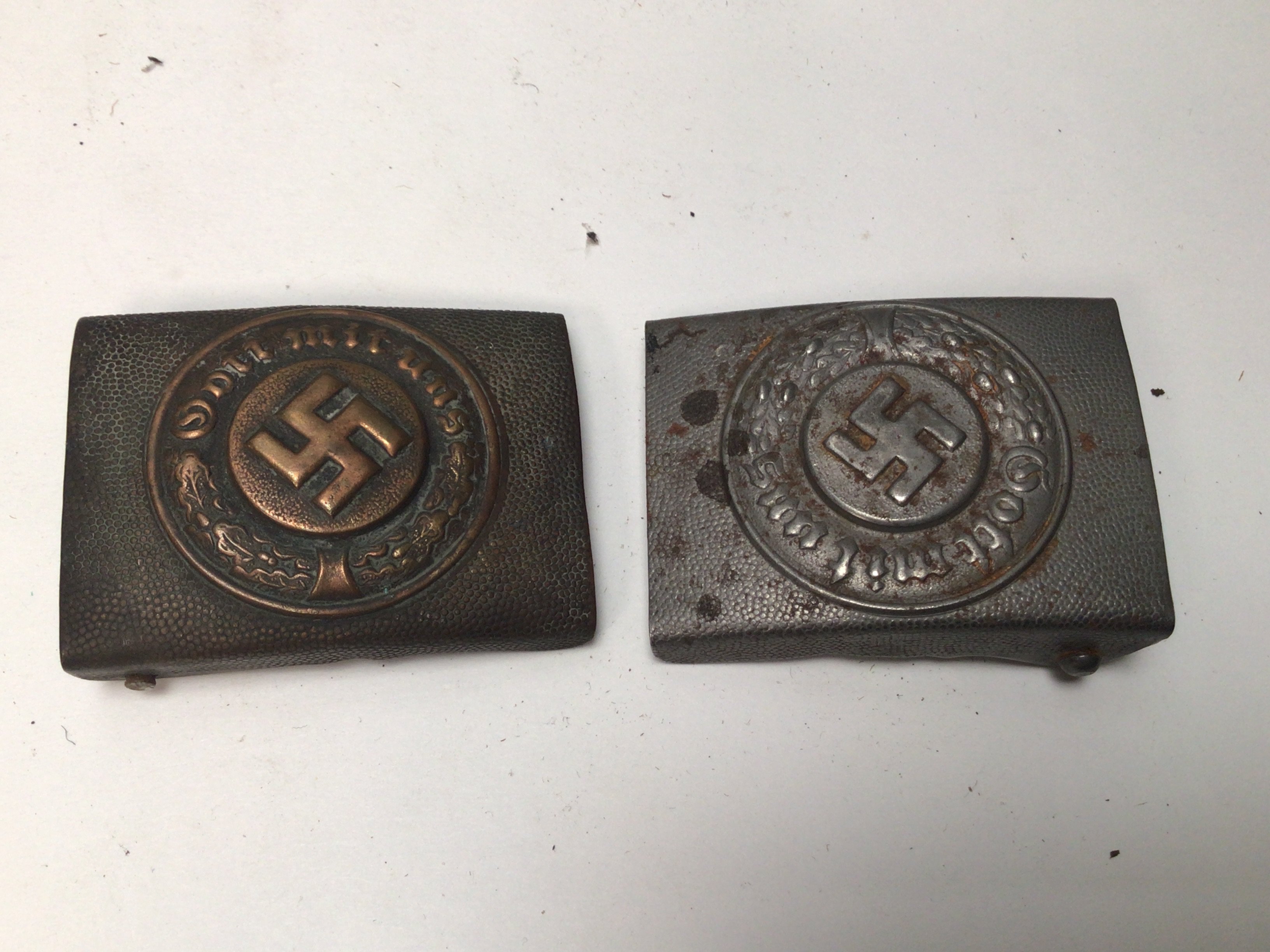Two German Third Reich Combat Police belt buckles. Copper finish with makers name and aluminium patterned finish (2)