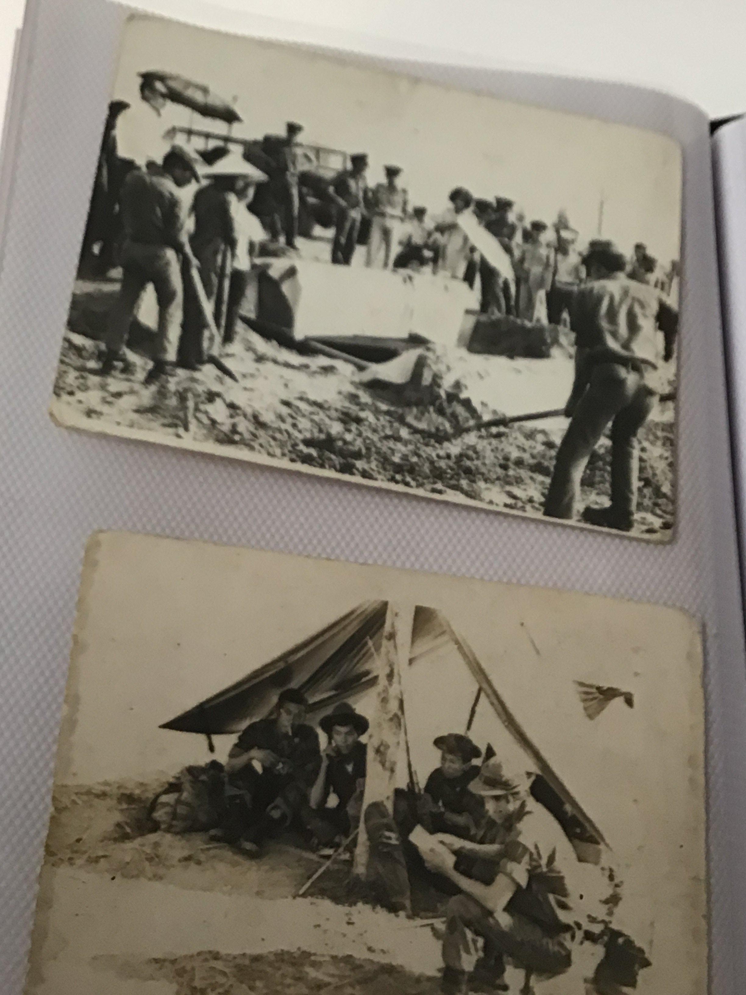 An album containing German II world war photographs bank notes Vietnam photos including military burials.