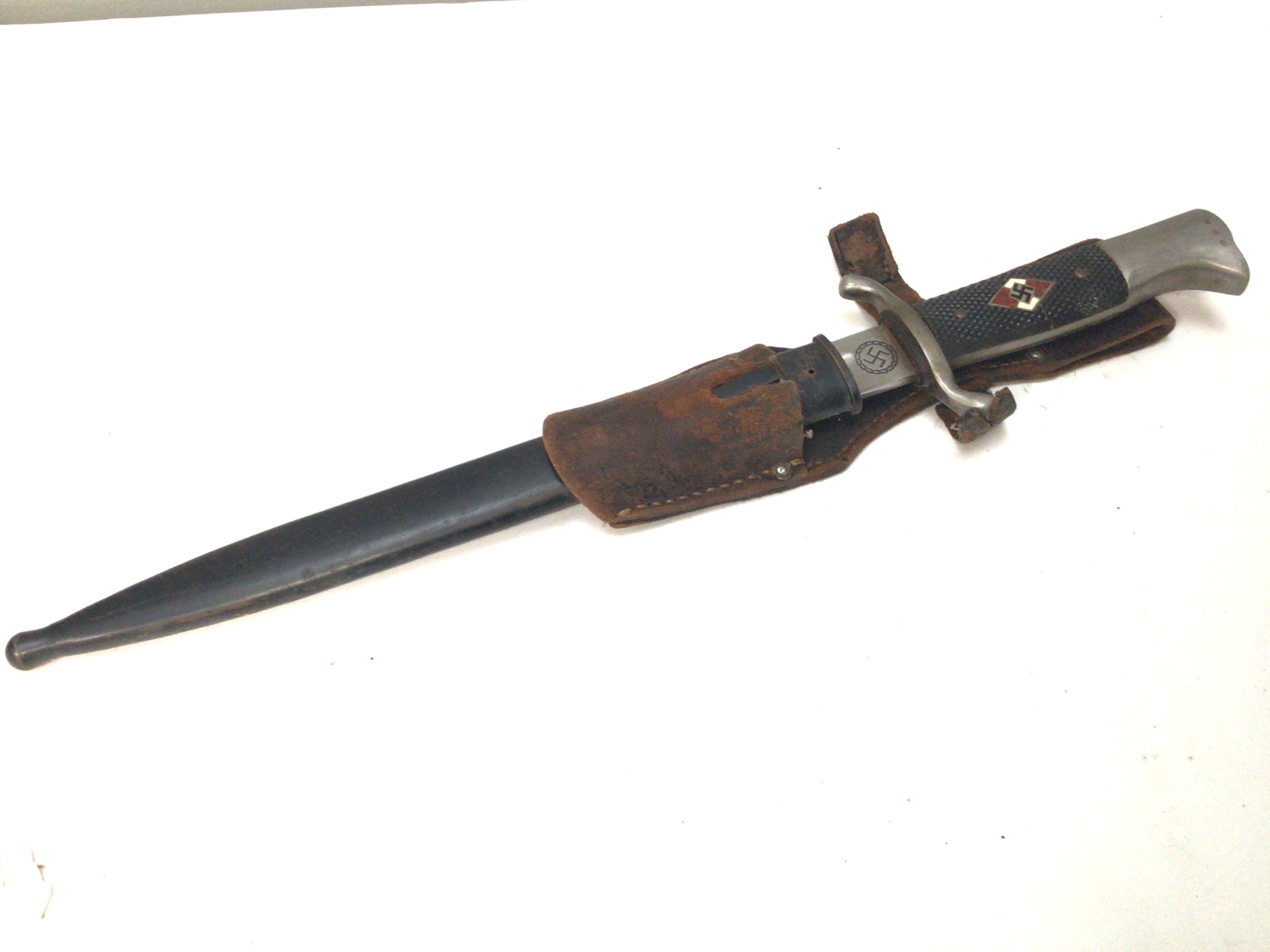A good example of a German Hitler Youth dress bayonet with enamel decoration. Marks to the blade leather frog black steel scabbard.