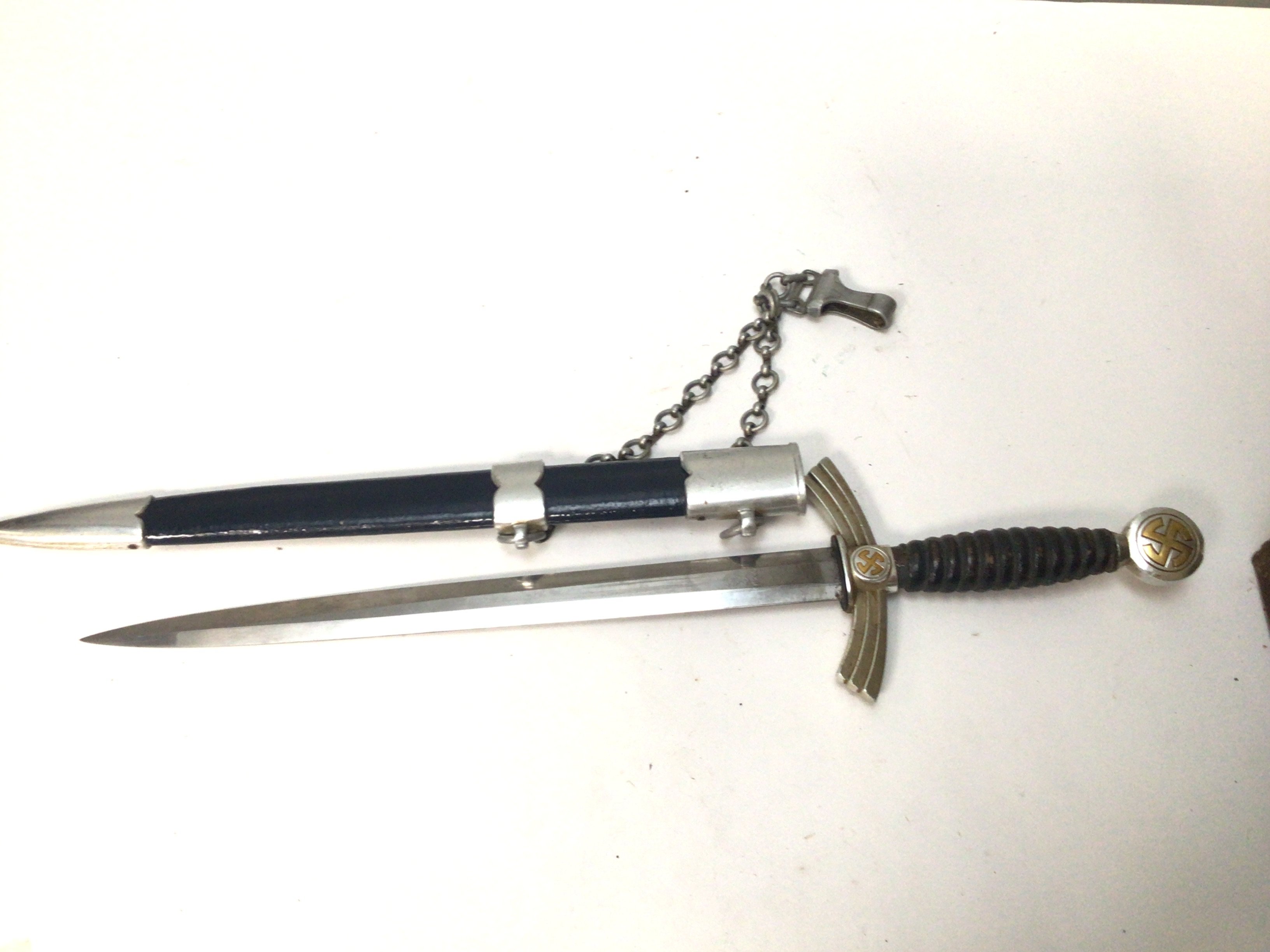 A German Third Reich first pattern Luftwaffa dagger with aluminium chain hanger makers stamp to the blade WKC leather and metal scabbed.