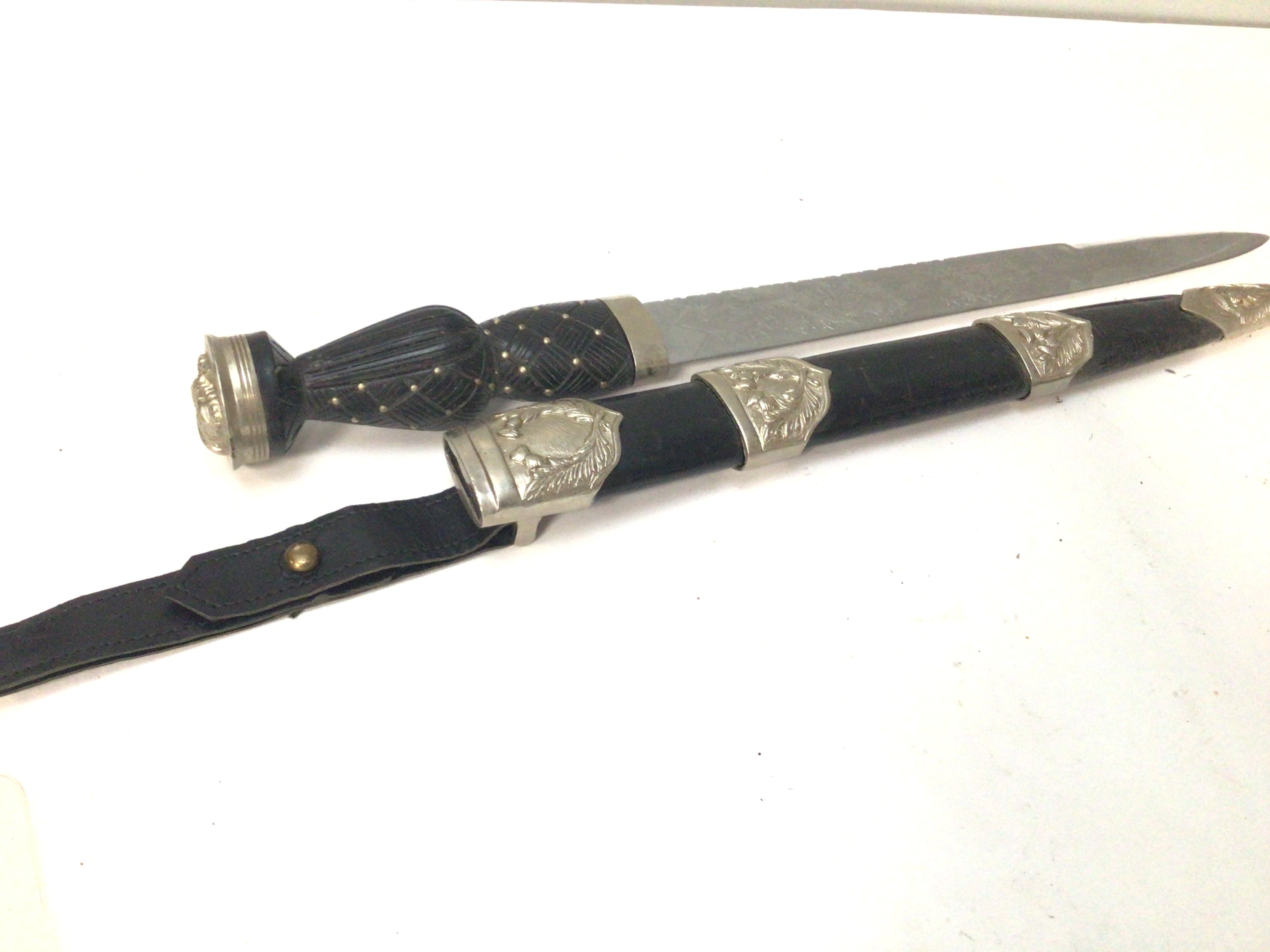 A Scottish Derk with an elaborate etched blade crown pommel.