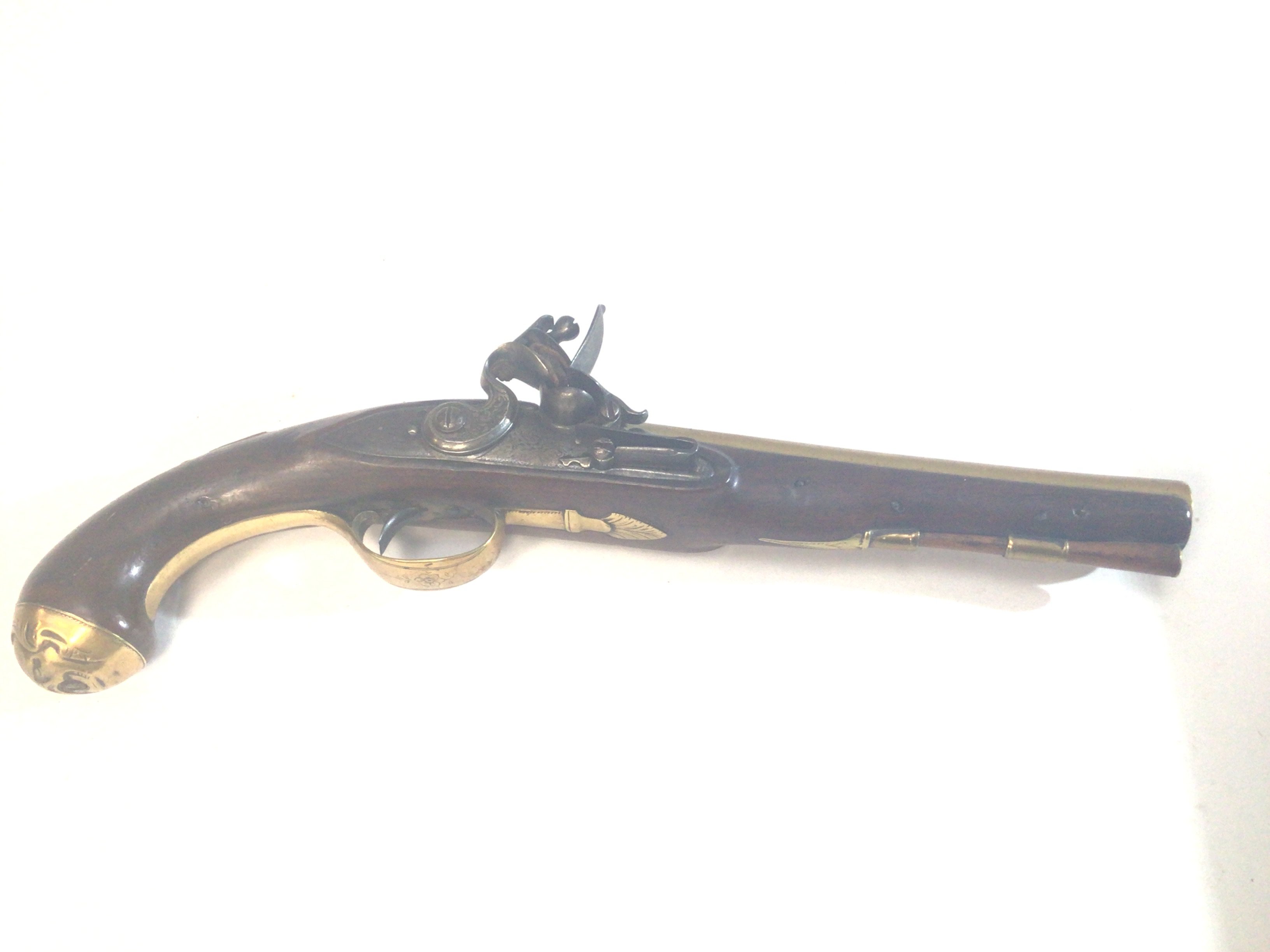 A Nice Example of British Brass barrelled Flintlock 18th century pistol the stock end with applied brass ornamentation the barrel with several proof marks brass trigger guard steel action.