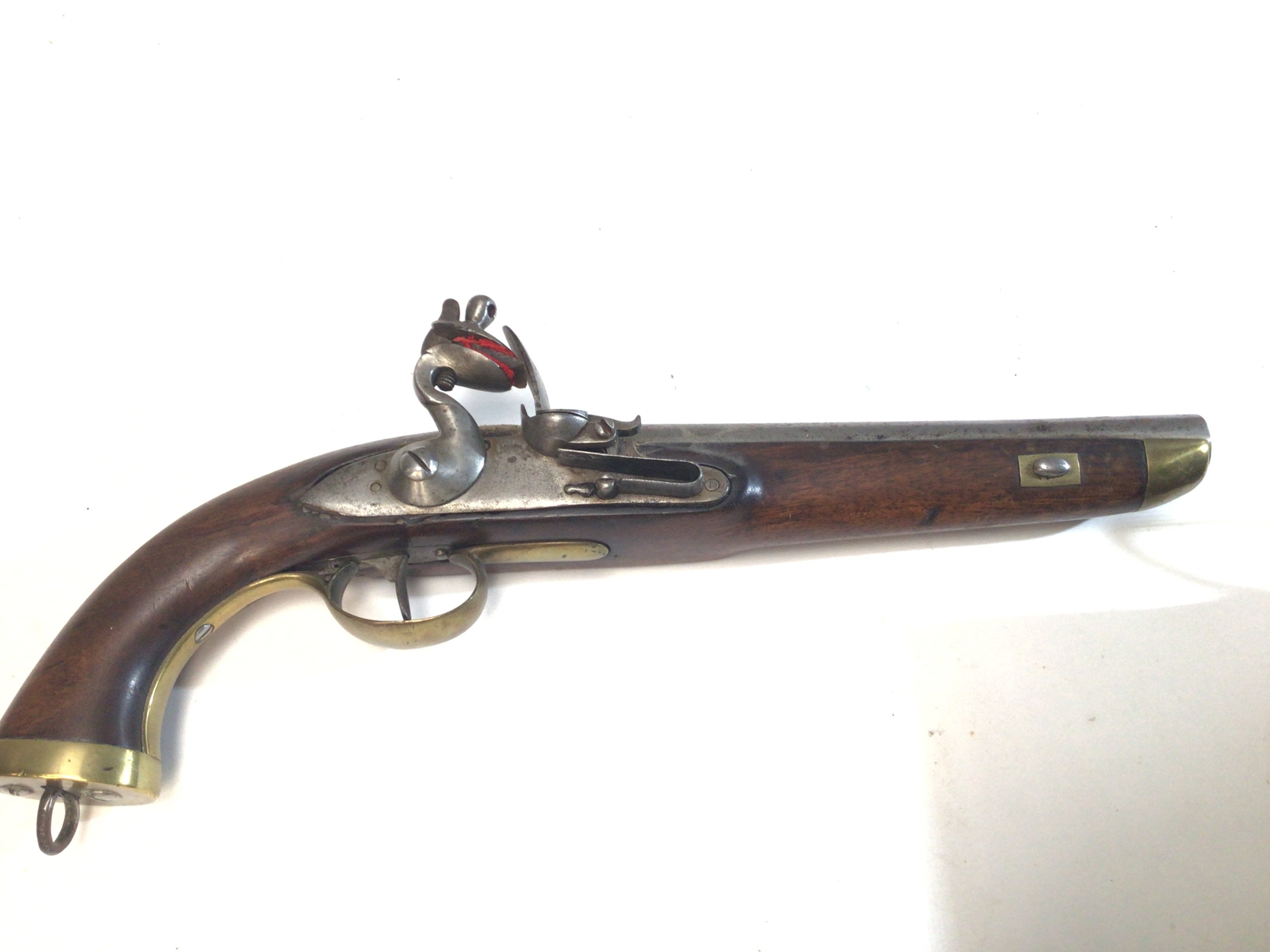 A late 18th Century flintlock pistol possibly military issue the brass fittings with attachment ring steel action and barrel.