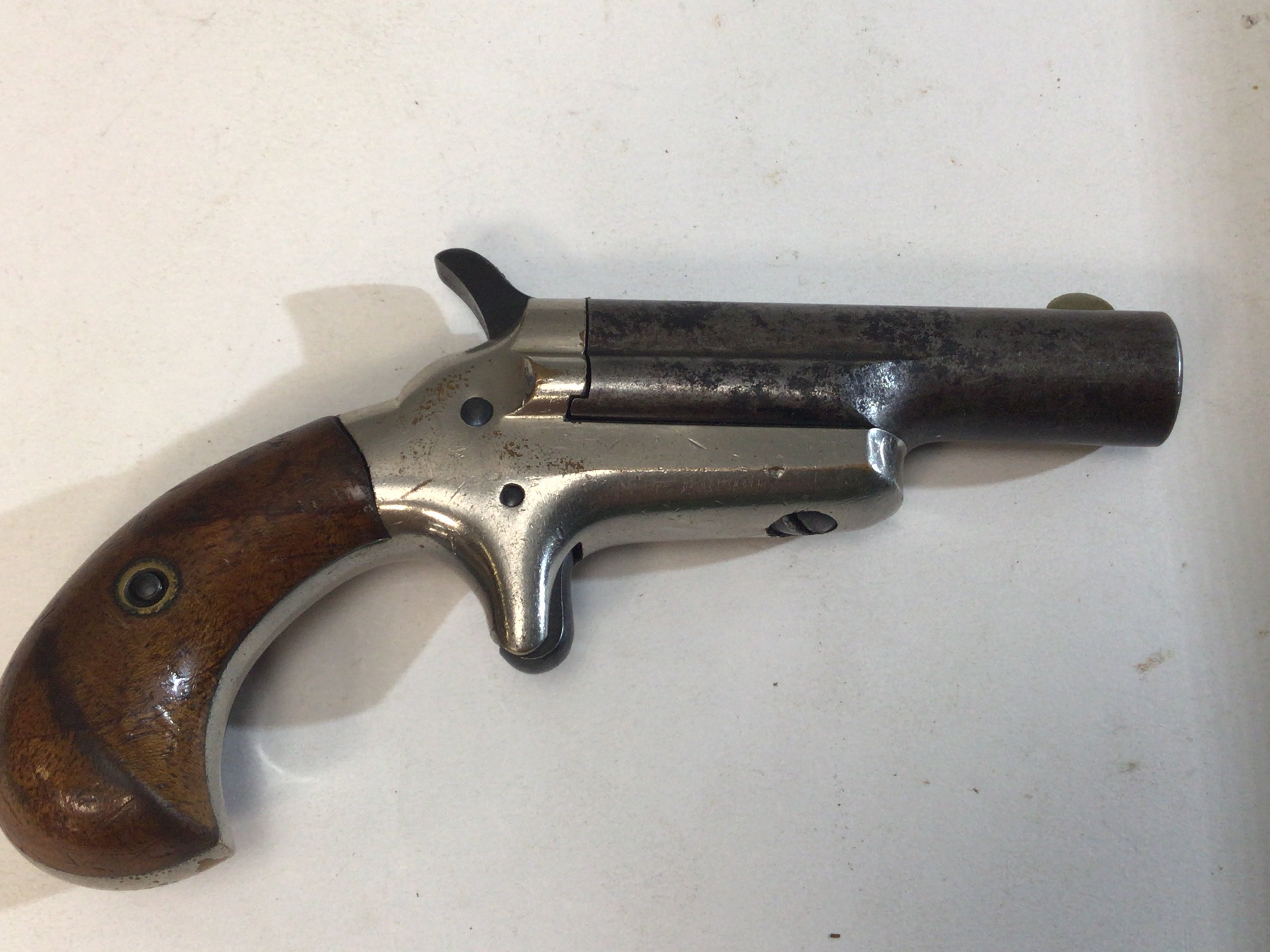An intresting Belgium made antique pistol,of a .41 caliber colt pistol no visible serial number stamped Colt and with 41 Caliber stamp marks circa 1885, with steel barrel, solid nickel open frame with spur trigger and exposed hammer and smooth walnut birdshead grips.