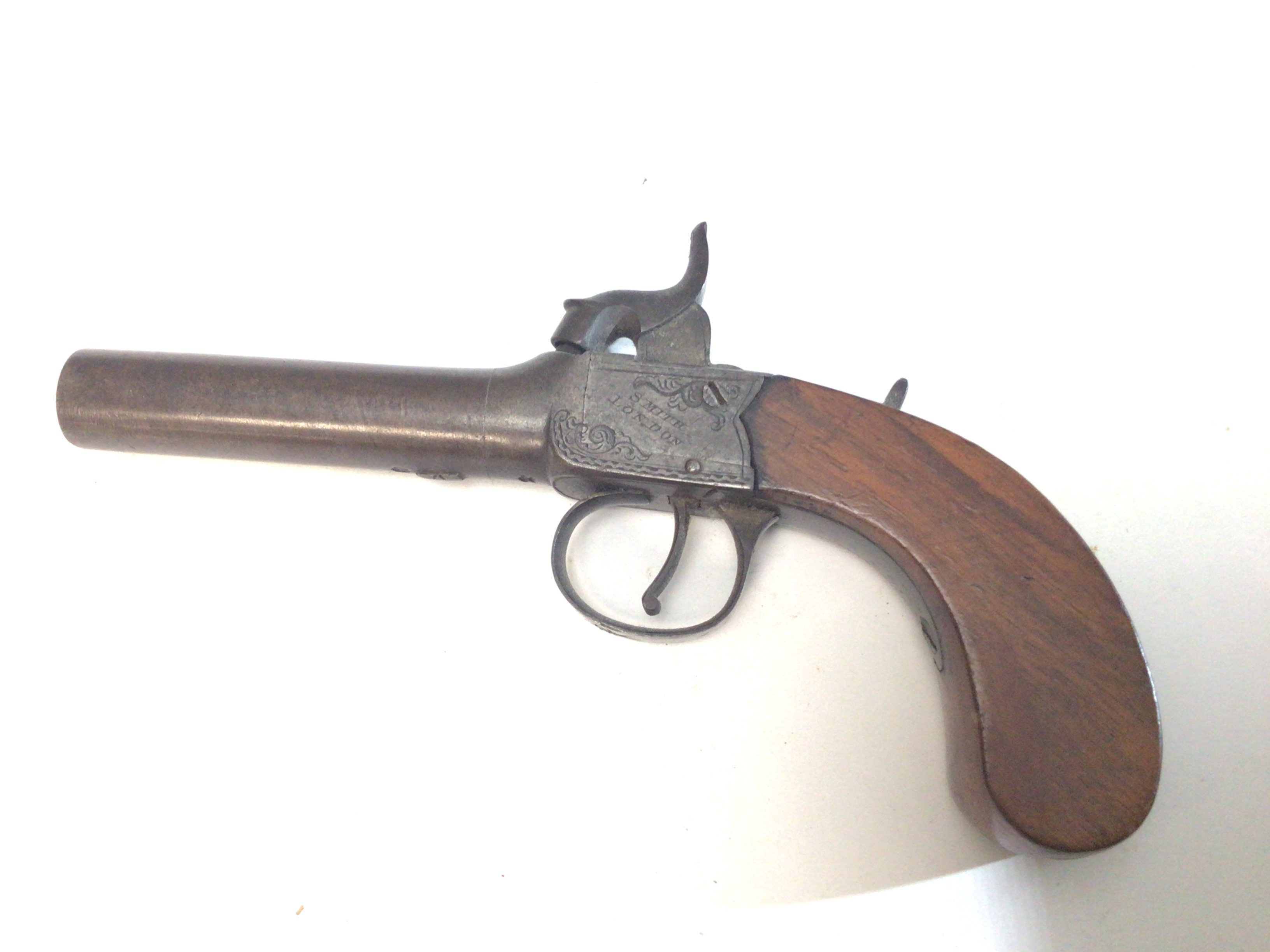 A 19th century Percussion pistol maker Smith London with a detachable barrel with proof marks slab sided. Length 18cm