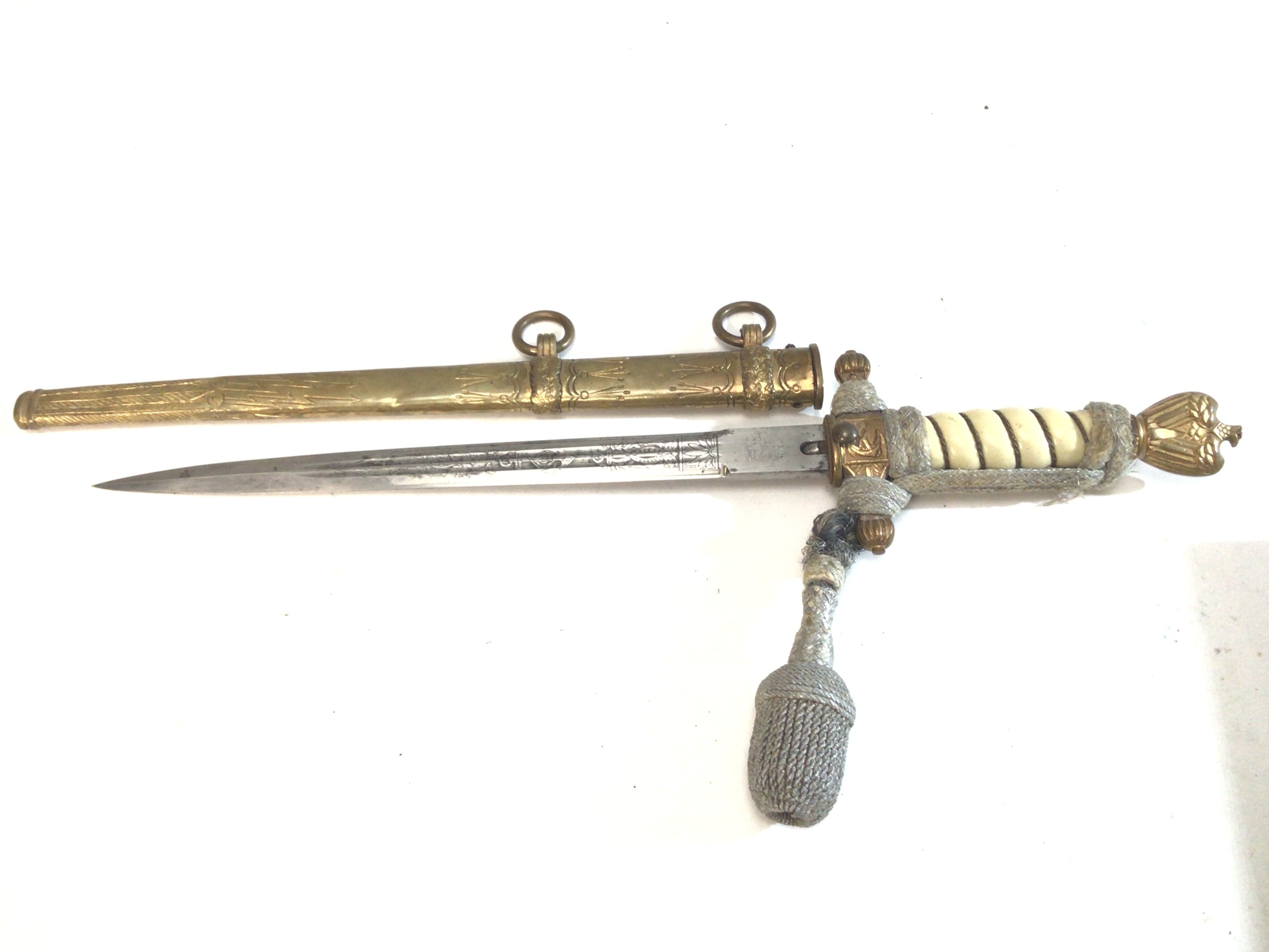 A German II world war Third Reich Kriegsmarine officers presentation dagger with attached pommel the etched blade with makers stamp.
