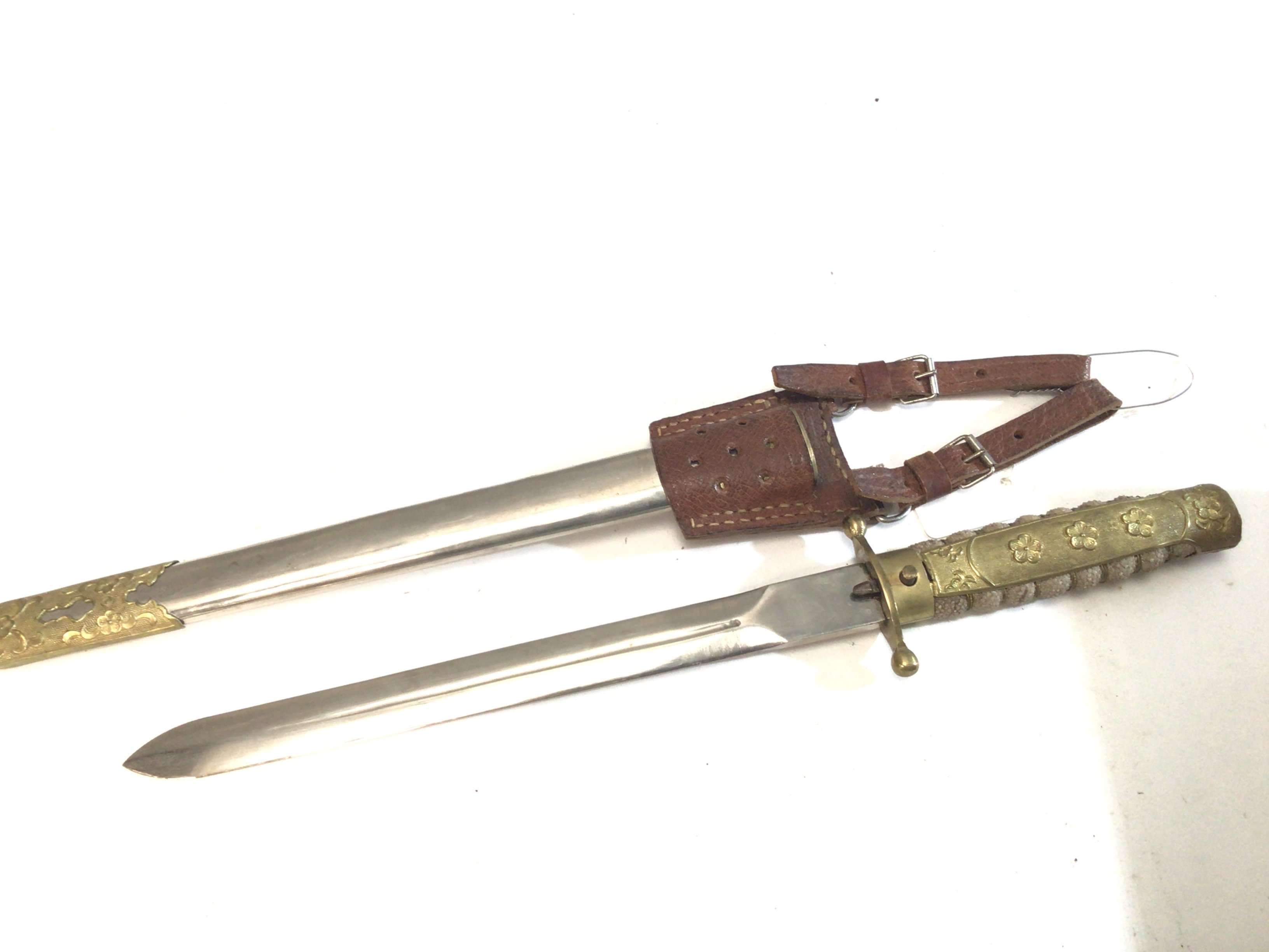 A Rare Chinese Republic Military officers presentation dagger with a shagreen grip with applied gilt metal ornamentation. Leather frog.