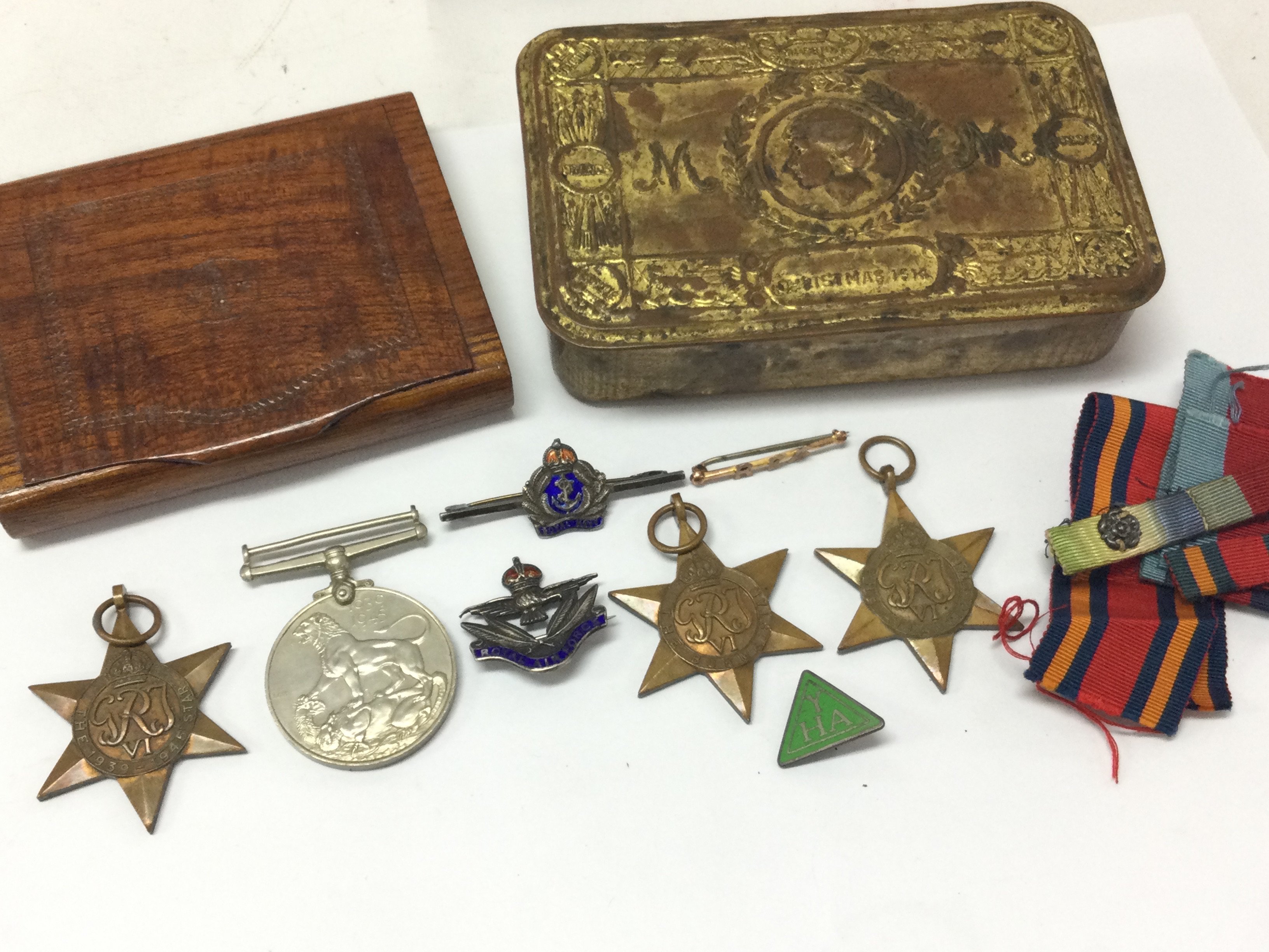 A collection of WW2 medals including Atlantic star, Burma star, 1939-45 star, War medal , RAF pin, Royal Navy pin, enamel youth hostel badge, RFA pin, WW1 Christmas tin. Postage category B