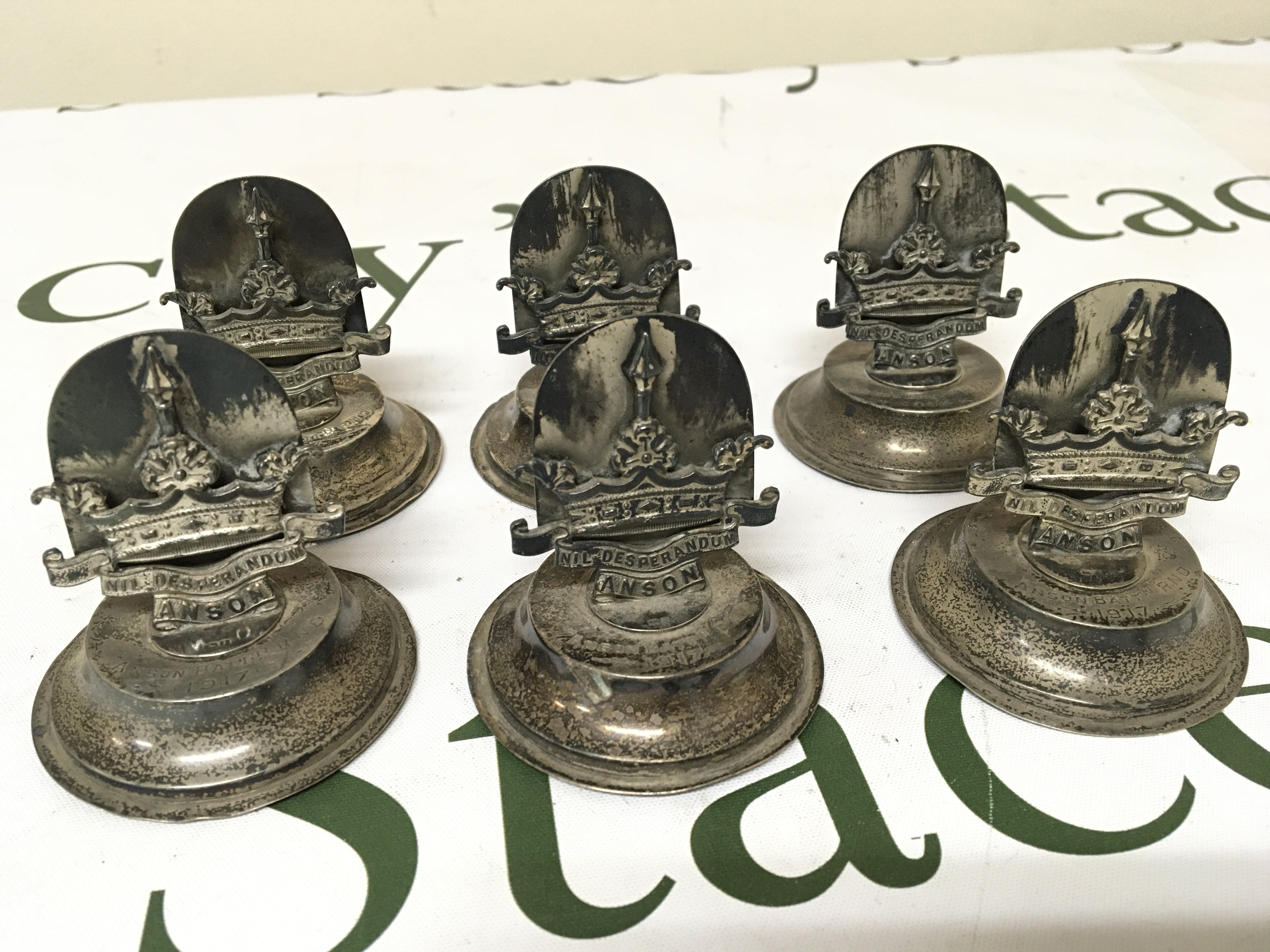 A rare and interesting set of six British Royal Navy silver menu holders dated 1917 the silver holders with the badge of the Anson Battalion. These troops where Royal Navy Volunteers who fought land battles.The Seafied boys. Battles included the Siege of Antwerp Salonica The Western Front and the attempt on Sulva Bay Gallipoli. Rare and possible unique silver menu holders.