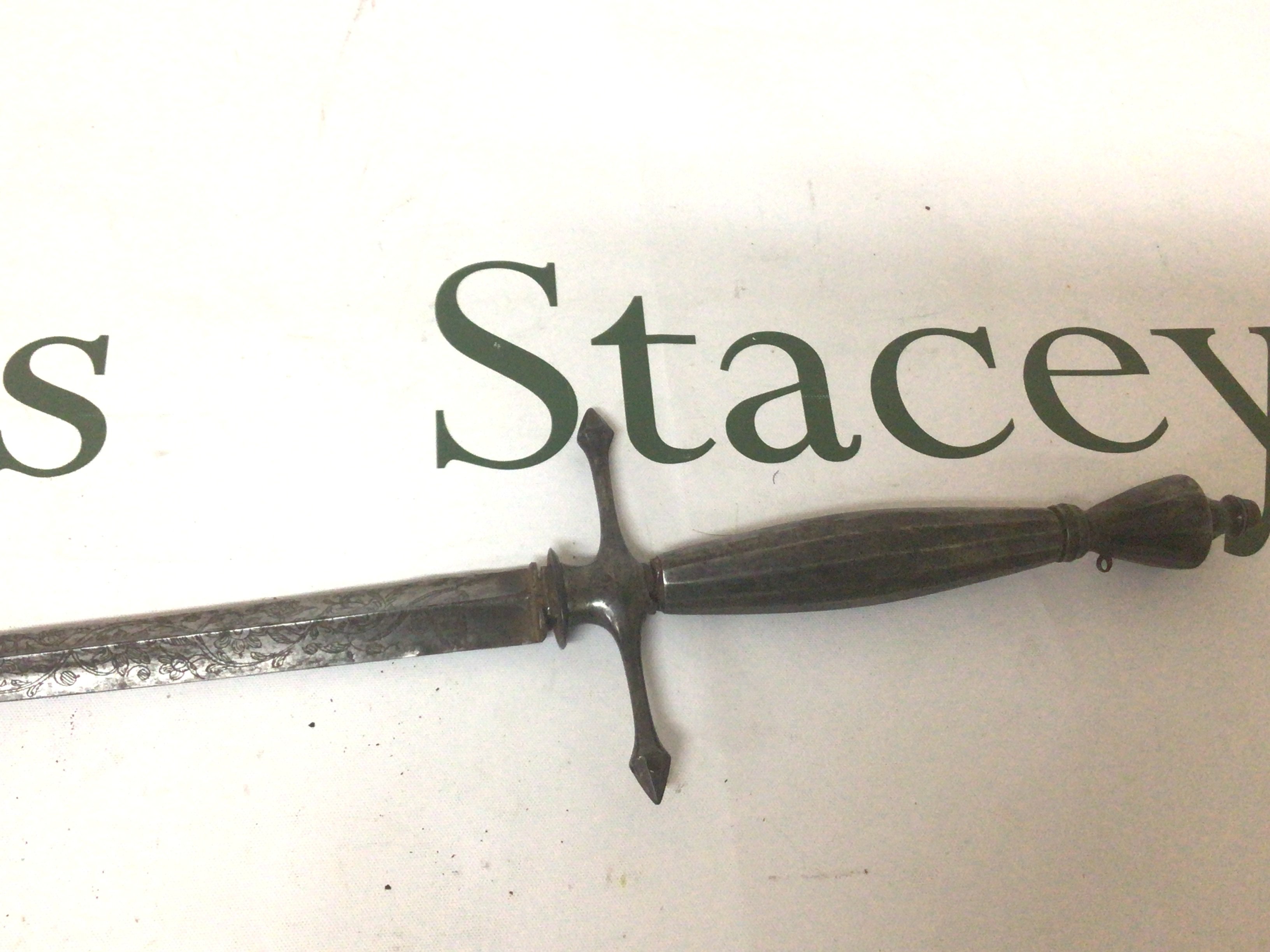 An 18th Century steel Court Sword Continental possibly French with a steel grip the tapering inverted triangle blade and engraved floral pattern. No scabbard length 97cm