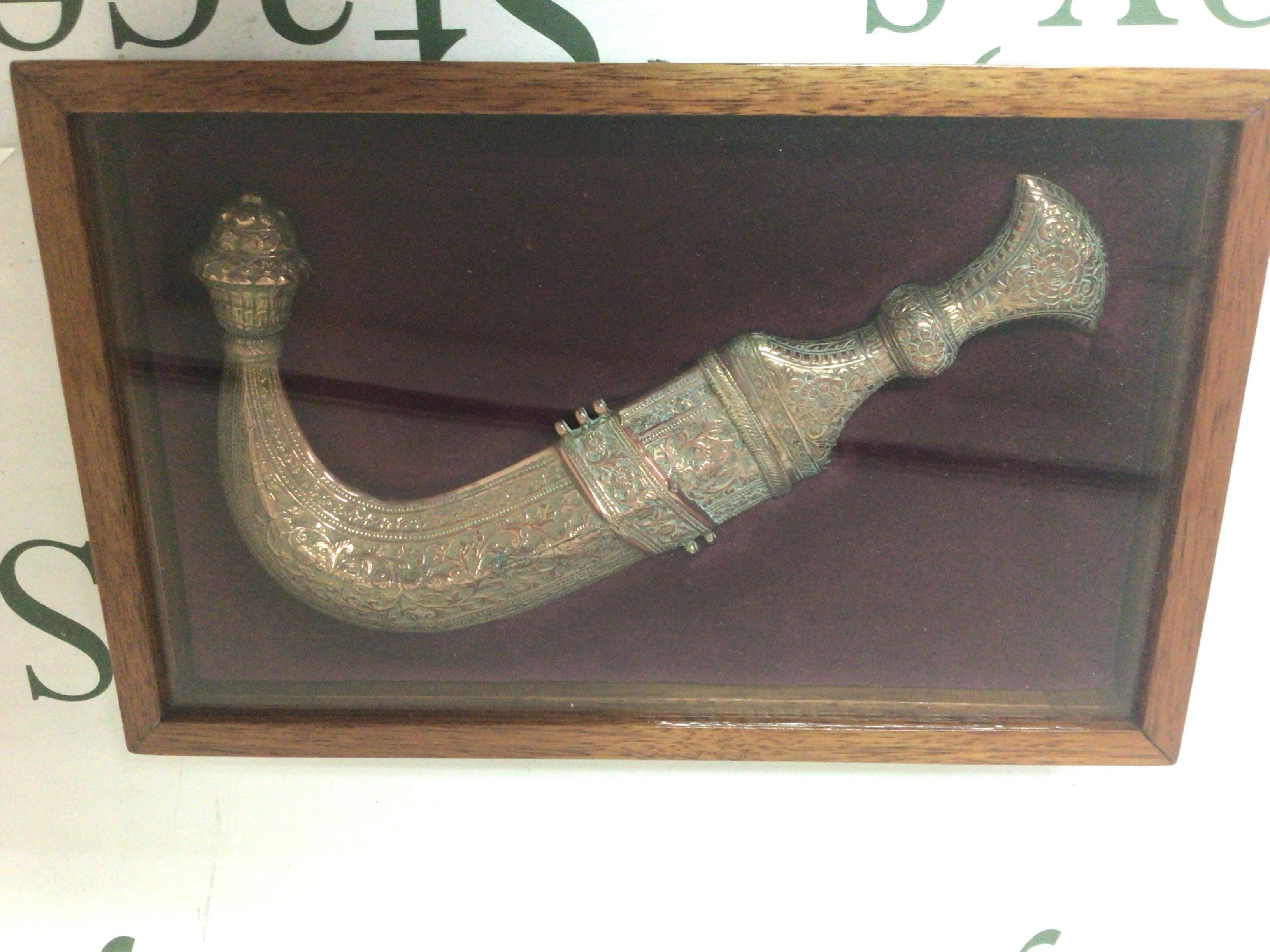 A brass Islamic Jambiya Knife from the Arabian Peninsula the scabbard and grip with perfuse folate pattern in a fitted case sealed.