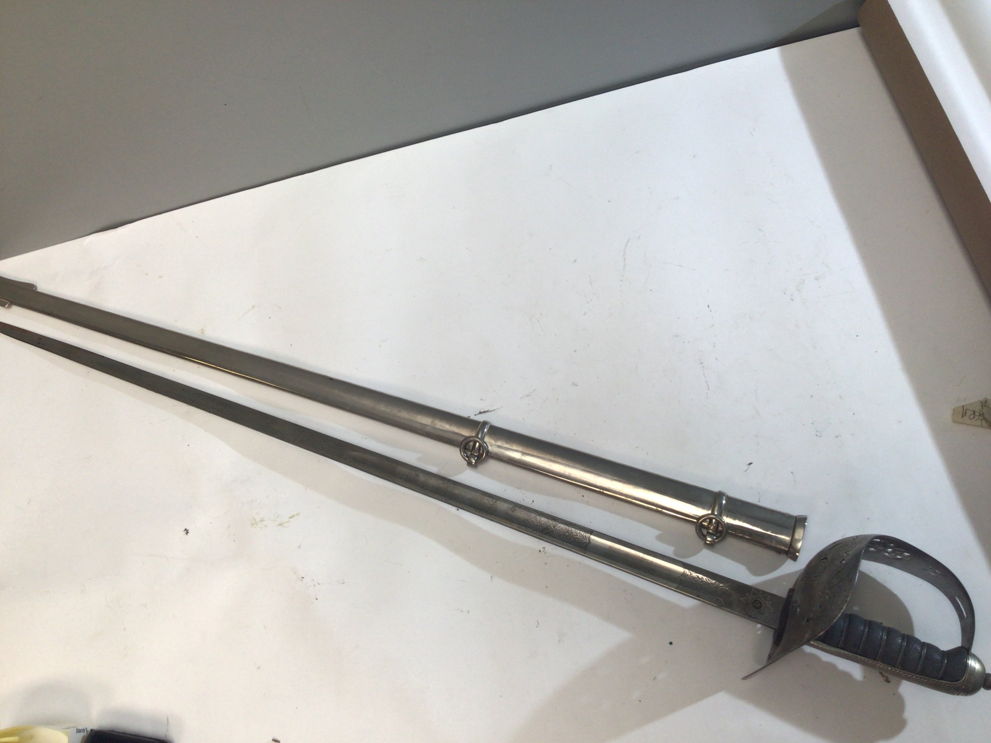 A George V British Military officers sword made by Wilkinson Newark the etched blade with badge and Coats of Arms. Metal scabbed.