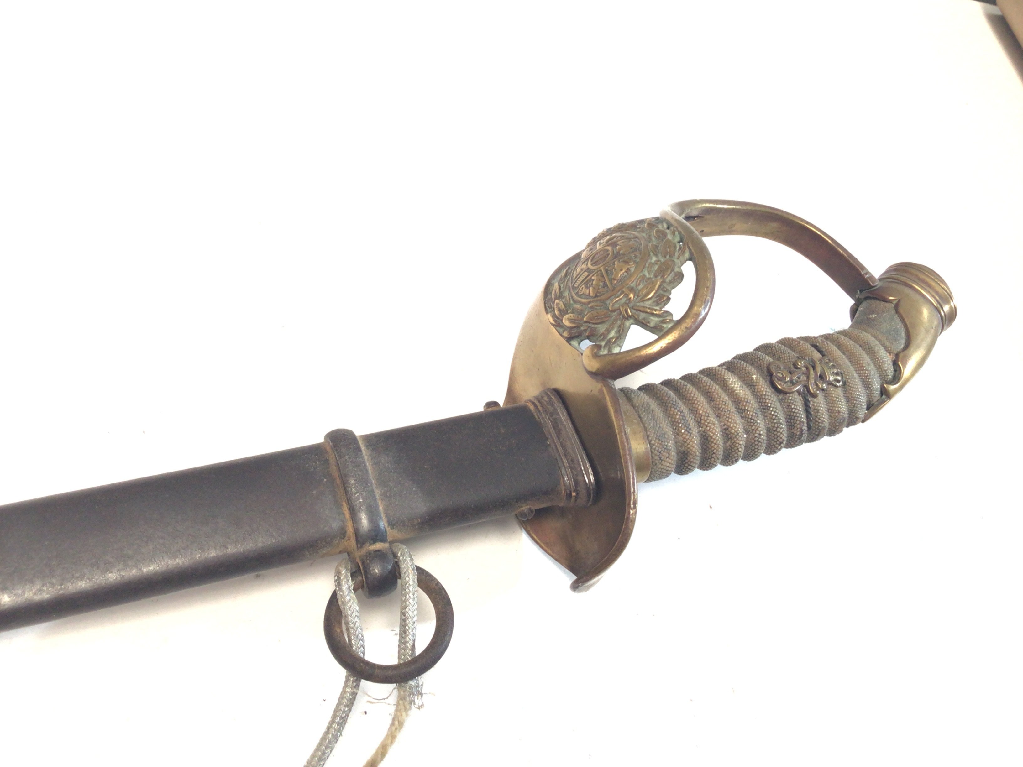 A German Imperial officers sword 1889 pattern the shagreen grip with applied lettering the brass Guard with a crest within a Laurel leaf.