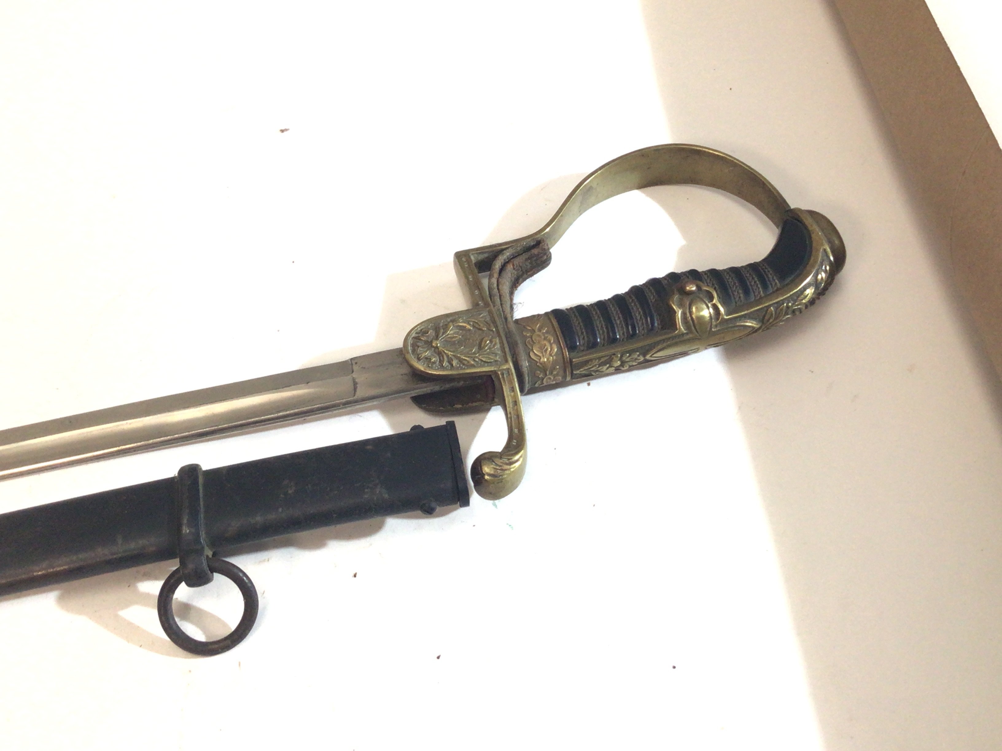 A German Third Reich Military officers dress sword with dove head ornate brass Guard makers stamp to the blade